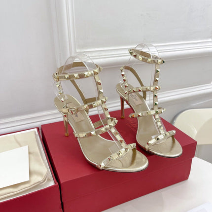 ROCKSTUD 100 GOLD METALLIC CALFSKIN ANKLE STRAP HIGH SANDAL