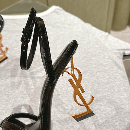 YSL 25S HIGH-HEEL SANDALS 100 MM IN BLACK GLOSSY LAMBSKIN WITH YSL LOGO HEEL DESIGN IN GOLD