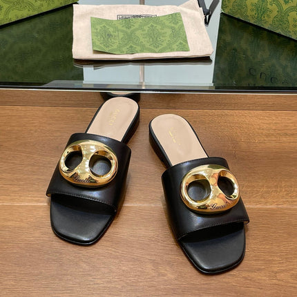 FLAT MULE IN BLACK CALFSKIN WITH GOLD HARDWARE