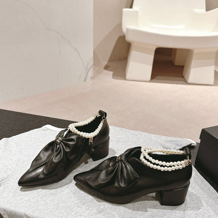 SHORT BOOTS IN BLACK SHEEPSKIN WITH BOW