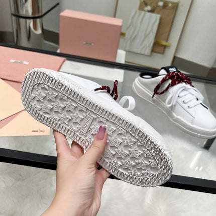 SNEAKER MULES IN BLACK AND WHITE CALFSKIN WHITE RED LACES