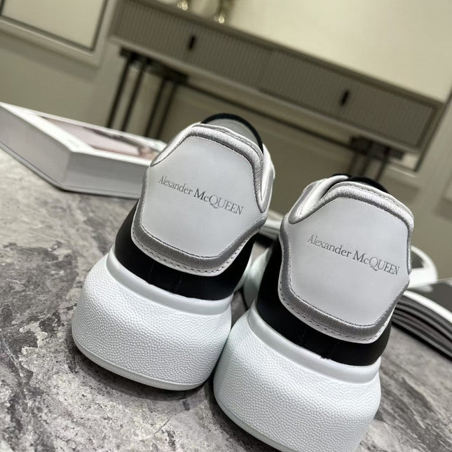 OVERSIZED SNEAKER IN BLACK CALFSKIN WITH SILVER STITCHED WHITE HEEL TAB