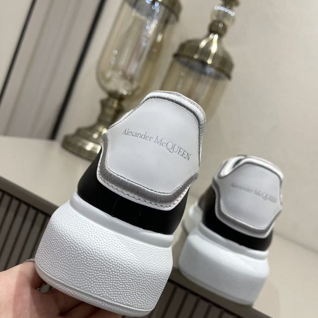 OVERSIZED SNEAKER IN BLACK CALFSKIN WITH SILVER STITCHED WHITE HEEL TAB