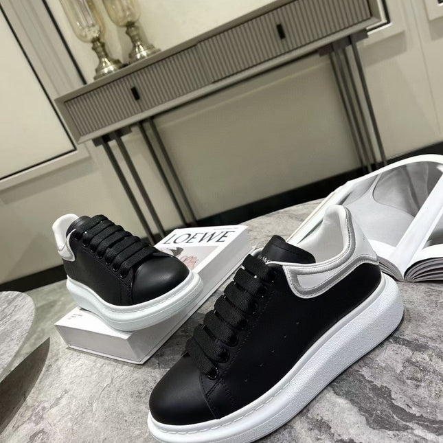 OVERSIZED SNEAKER IN BLACK CALFSKIN WITH SILVER STITCHED WHITE HEEL TAB