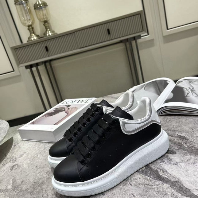 OVERSIZED SNEAKER IN BLACK CALFSKIN WITH SILVER STITCHED WHITE HEEL TAB