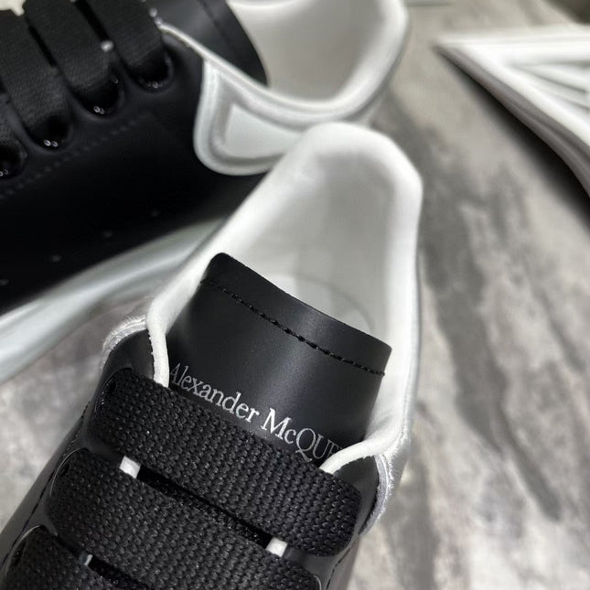 OVERSIZED SNEAKER IN BLACK CALFSKIN WITH SILVER STITCHED WHITE HEEL TAB