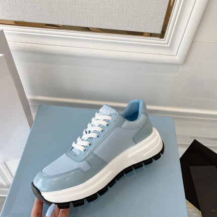PRADA 25S THICK SOLE SNEAKER IN LIGHT BLUE CALFSKIN AND CANVAS