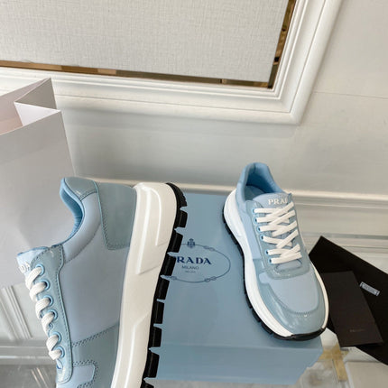 PRADA 25S THICK SOLE SNEAKER IN LIGHT BLUE CALFSKIN AND CANVAS