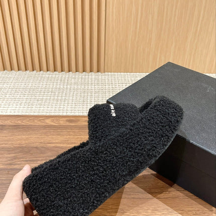CHUNKY PLATFORM SIPPERS IN BLACK LAMBSWOOL