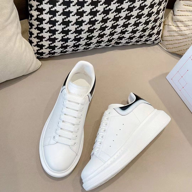 OVERSIZED SNEAKER IN WHITE CALFSKIN WITH GLOSSY BLACK AND WHITE HEEL TAB