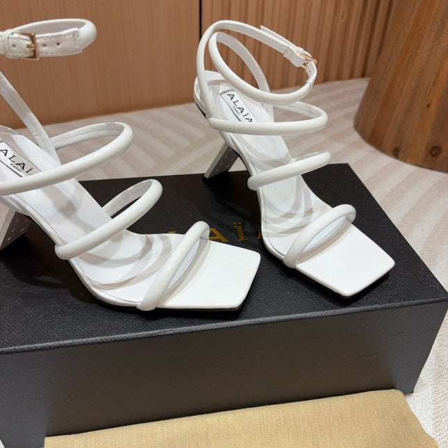 ALAIA THREE-STRAPS HIGH HEEL SANDALS IN WHITE PATENT LAMBSKIN