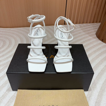 ALAIA THREE-STRAPS HIGH HEEL SANDALS IN WHITE PATENT LAMBSKIN