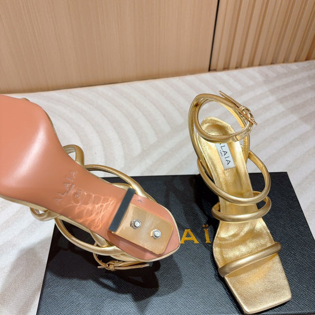 ALAIA THREE-STRAPS HIGH HEEL SANDALS IN GOLDEN PATENT LAMBSKIN