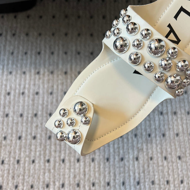 ALAIA FOLDED FLAT MULES WITH SPHERES ON WHITE CALFSKIN