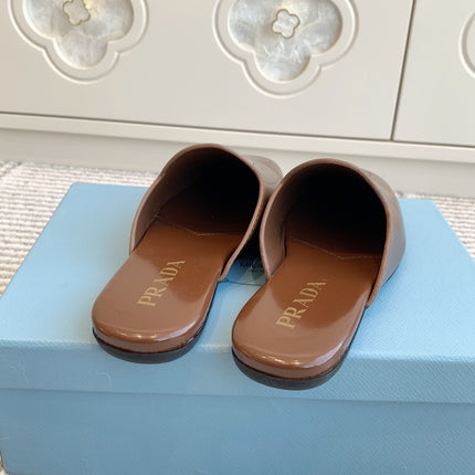 MULES IN BROWN GLOSSY SHEEPSKIN GOLD LETTERING LOGO