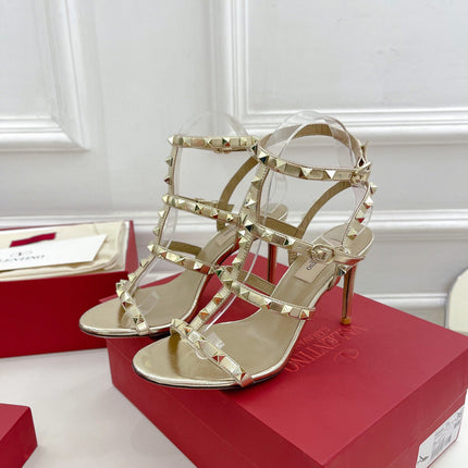 ROCKSTUD 100 GOLD METALLIC CALFSKIN ANKLE STRAP HIGH SANDAL