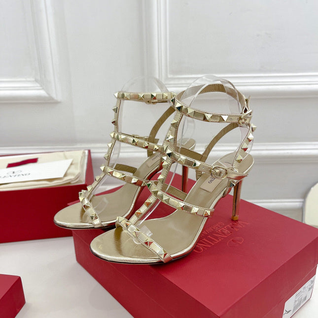 ROCKSTUD 100 GOLD METALLIC CALFSKIN ANKLE STRAP HIGH SANDAL