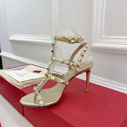 ROCKSTUD 100 GOLD METALLIC CALFSKIN ANKLE STRAP HIGH SANDAL