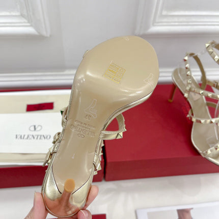 ROCKSTUD 100 GOLD METALLIC CALFSKIN ANKLE STRAP HIGH SANDAL