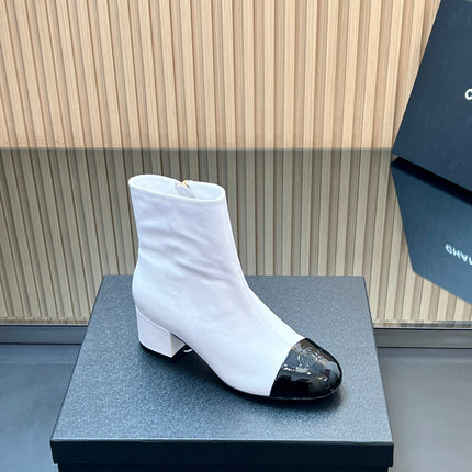 CHANEL 25S BOOTS WITH PATENT TOE CAP 50MM IN WHITE AND BLACK CALFSKIN