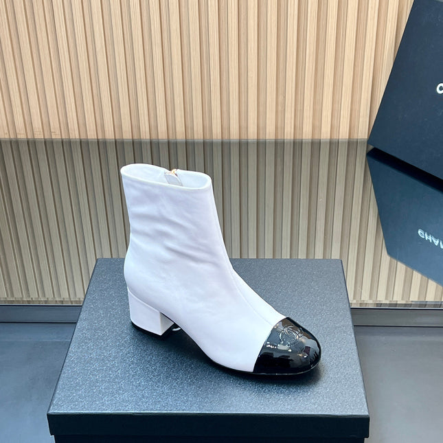 CHANEL 25S BOOTS WITH PATENT TOE CAP 50MM IN WHITE AND BLACK CALFSKIN