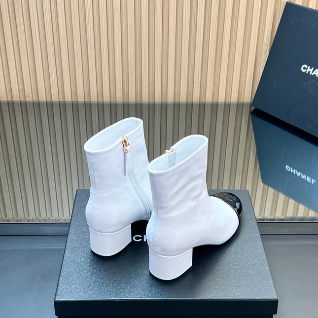 CHANEL 25S BOOTS WITH PATENT TOE CAP 50MM IN WHITE AND BLACK CALFSKIN