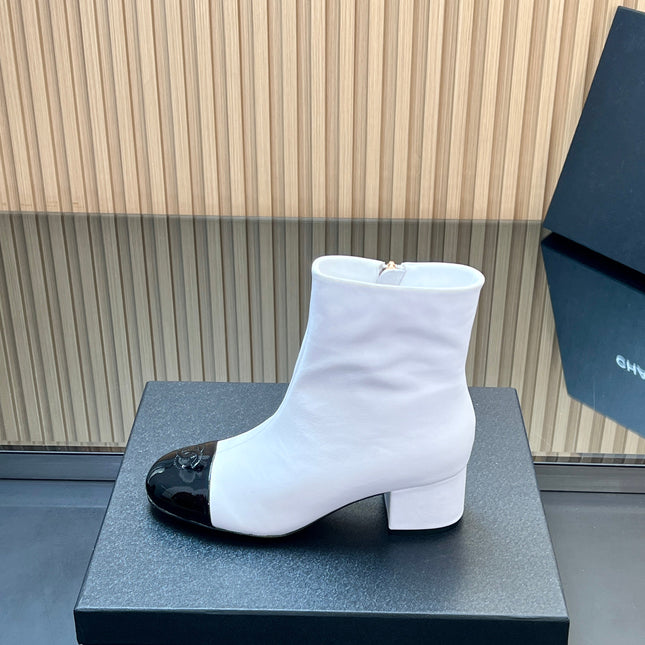 CHANEL 25S BOOTS WITH PATENT TOE CAP 50MM IN WHITE AND BLACK CALFSKIN