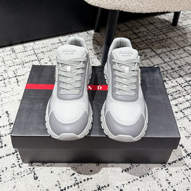 PRADA 25S MEN SNEAKERS IN GRAY AND WHITE CANVAS