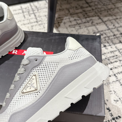 PRADA 25S MEN SNEAKERS IN GRAY AND WHITE CANVAS