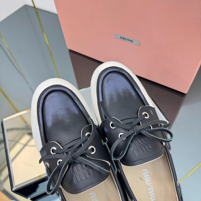 BOAT SHOES IN BLACK CALFSKIN AND WHITE CANVAS
