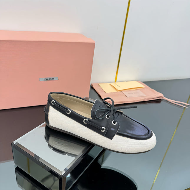 BOAT SHOES IN BLACK CALFSKIN AND WHITE CANVAS