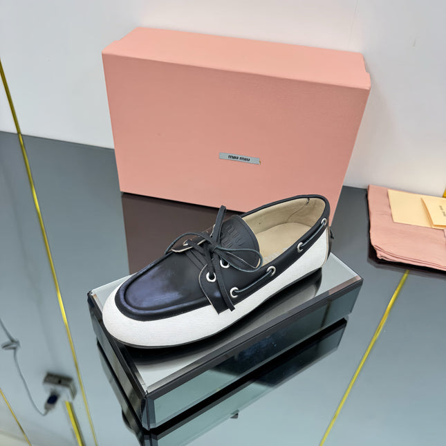 BOAT SHOES IN BLACK CALFSKIN AND WHITE CANVAS