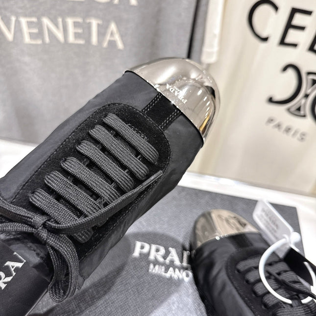 PRADA 25S MULES IN BLACK WITH METAL TOECAP