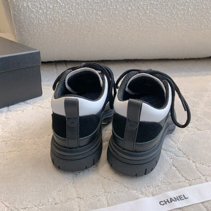 CHANEL 25S TRAINERS 40MM IN BLACK AND WHITE CALFSKIN AND SUEDE