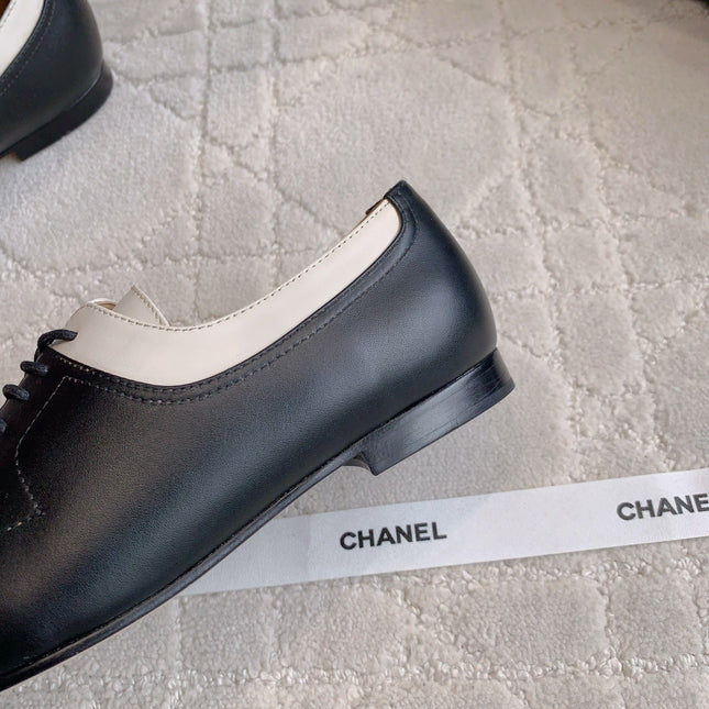 CHANEL 25S TWO TONE LACE UP IN BLACK AND WHITE CALFSKIN