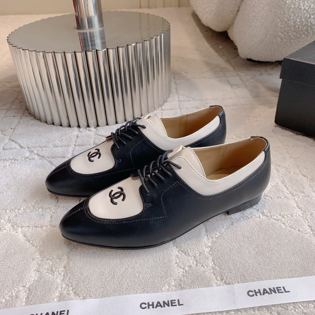 CHANEL 25S TWO TONE LACE UP IN BLACK AND WHITE CALFSKIN
