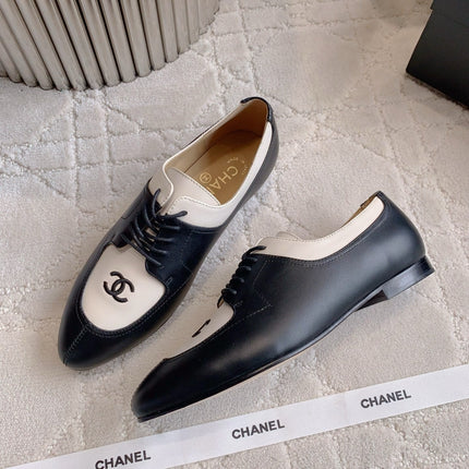 CHANEL 25S TWO TONE LACE UP IN BLACK AND WHITE CALFSKIN