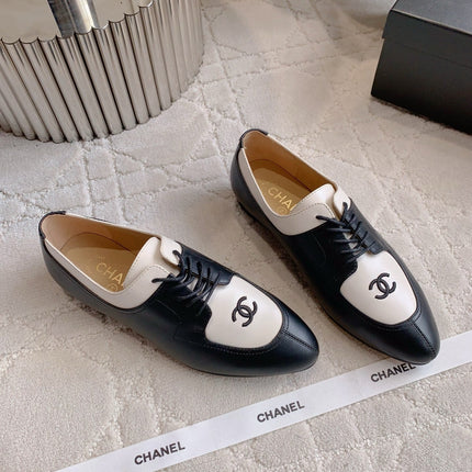 CHANEL 25S TWO TONE LACE UP IN BLACK AND WHITE CALFSKIN