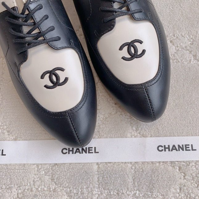 CHANEL 25S TWO TONE LACE UP IN BLACK AND WHITE CALFSKIN