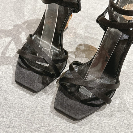 YSL 25S HIGH-HEEL SANDALS 100 MM IN BLACK SATIN WITH YSL LOGO HEEL DESIGN IN GOLD