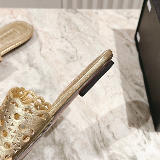 ALAIA PERFORATED SLIDE SANDALS 25S IN LIGHT GOLD LAMBSKIN