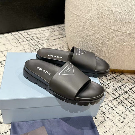 PRADA 25S RUBBER SLIDE IN BLACK CALFSKIN WITH LOGO