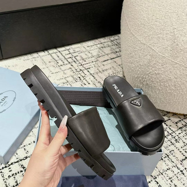PRADA 25S PADDED SLIDES IN BLACK CALFSKIN WITH LOGO