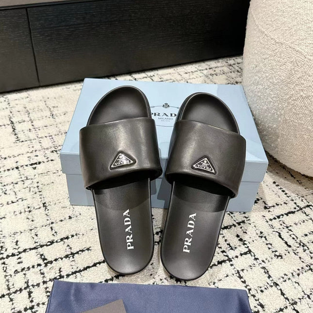 PRADA 25S PADDED SLIDES IN BLACK CALFSKIN WITH LOGO