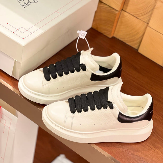 OVERSIZED SNEAKERS IN WHITE CALFSKIN BLACK HEEL BLACK LACES