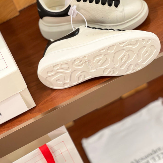 OVERSIZED SNEAKERS IN WHITE CALFSKIN BLACK HEEL BLACK LACES