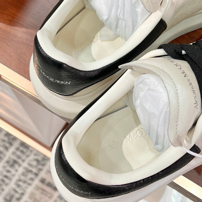 OVERSIZED SNEAKERS IN WHITE CALFSKIN BLACK HEEL BLACK LACES