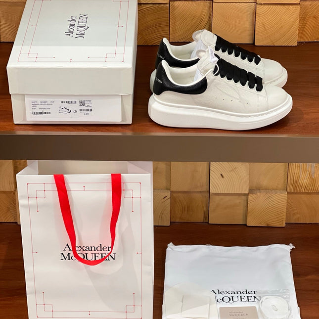 OVERSIZED SNEAKERS IN WHITE CALFSKIN BLACK HEEL BLACK LACES