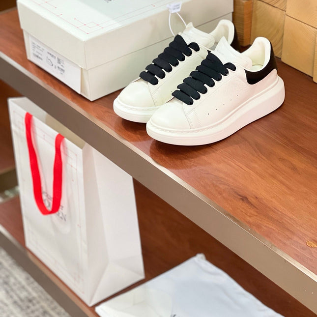 OVERSIZED SNEAKERS IN WHITE CALFSKIN BLACK HEEL BLACK LACES