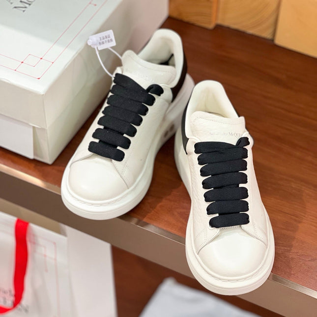 OVERSIZED SNEAKERS IN WHITE CALFSKIN BLACK HEEL BLACK LACES